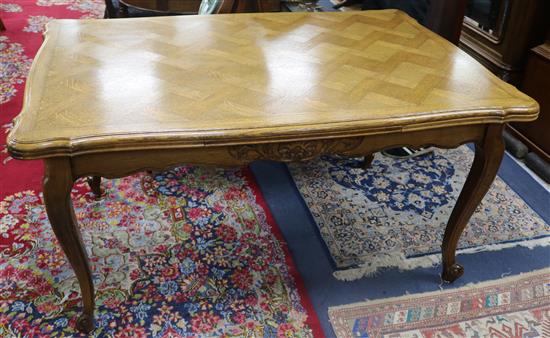 An early 20th century French parquetry oak draw leaf dining table W.150cm